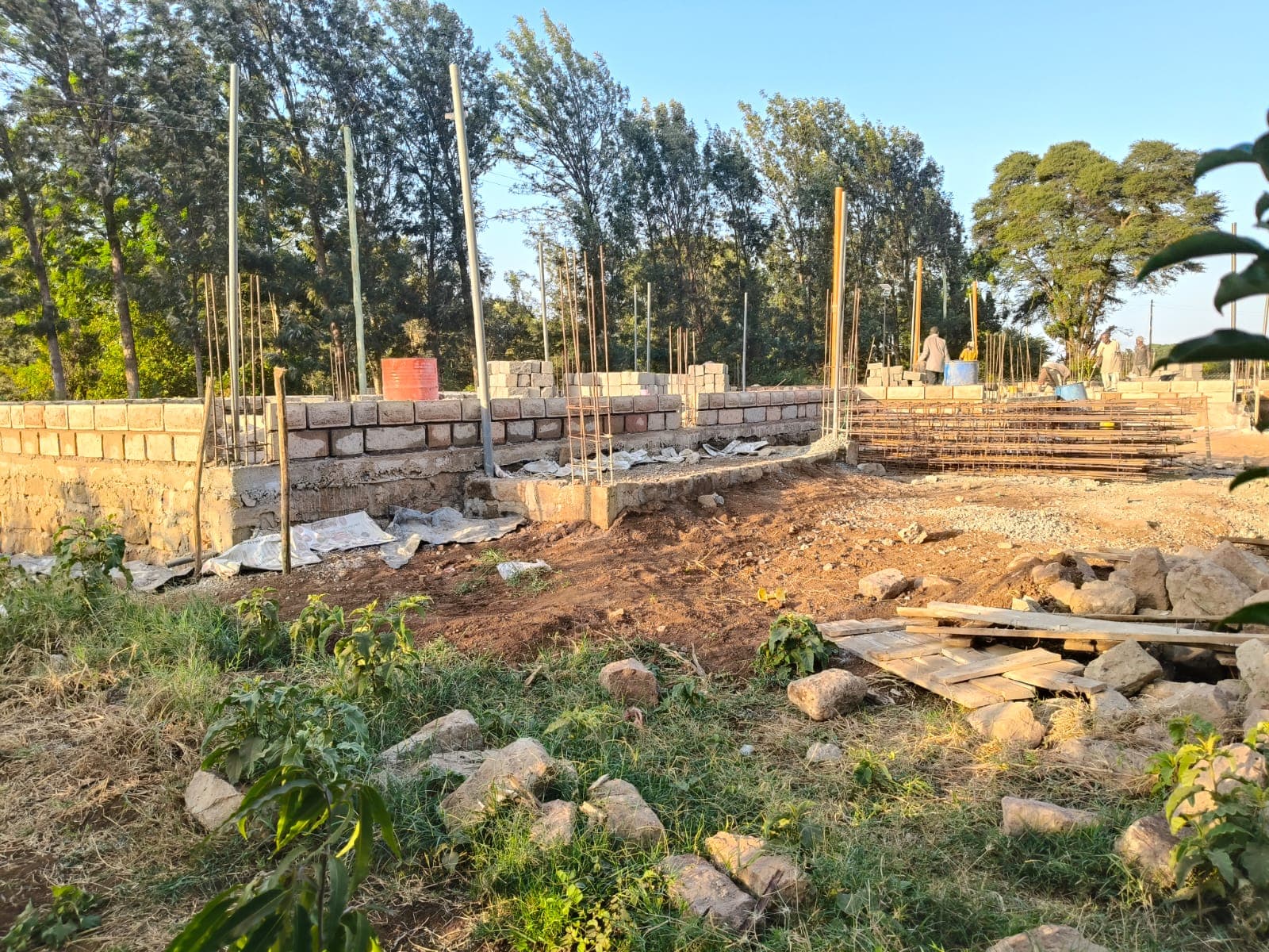 Block wall rising on a foundation in evening light