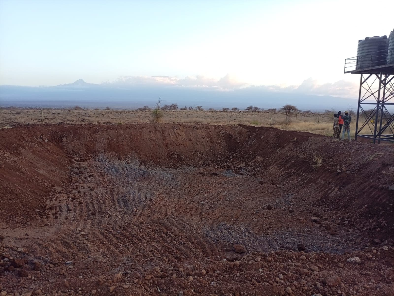 Panoramic view of a dam excavation with a mountain backdrop