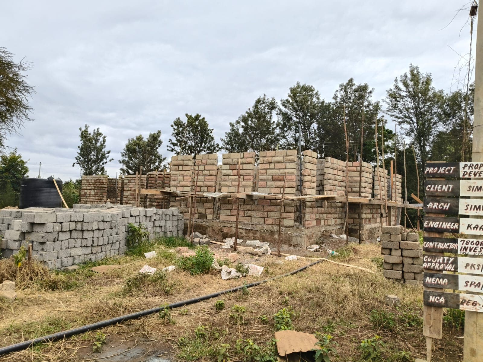 Block wall building site with project signboard