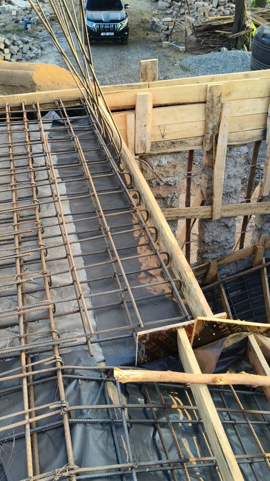 Close-up of a rebar slab mesh with waterproofing membrane