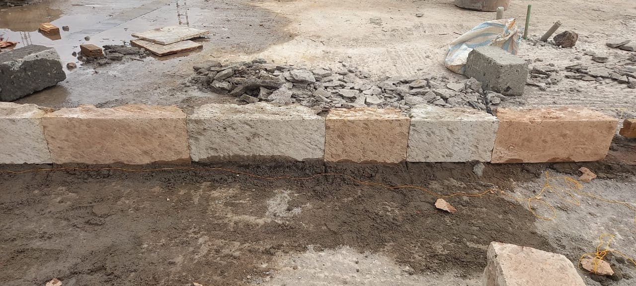 Close-up of dressed stone blocks along a foundation wall