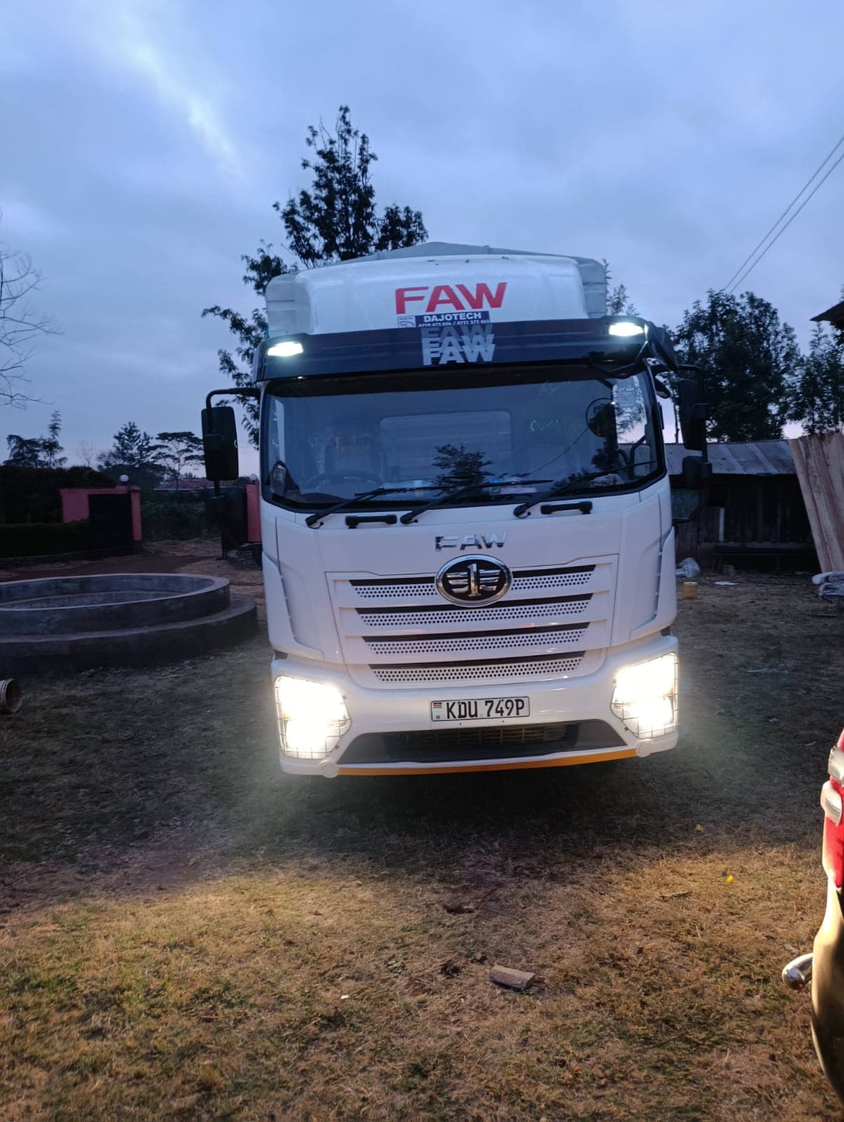 FAW curtain-side truck at dusk