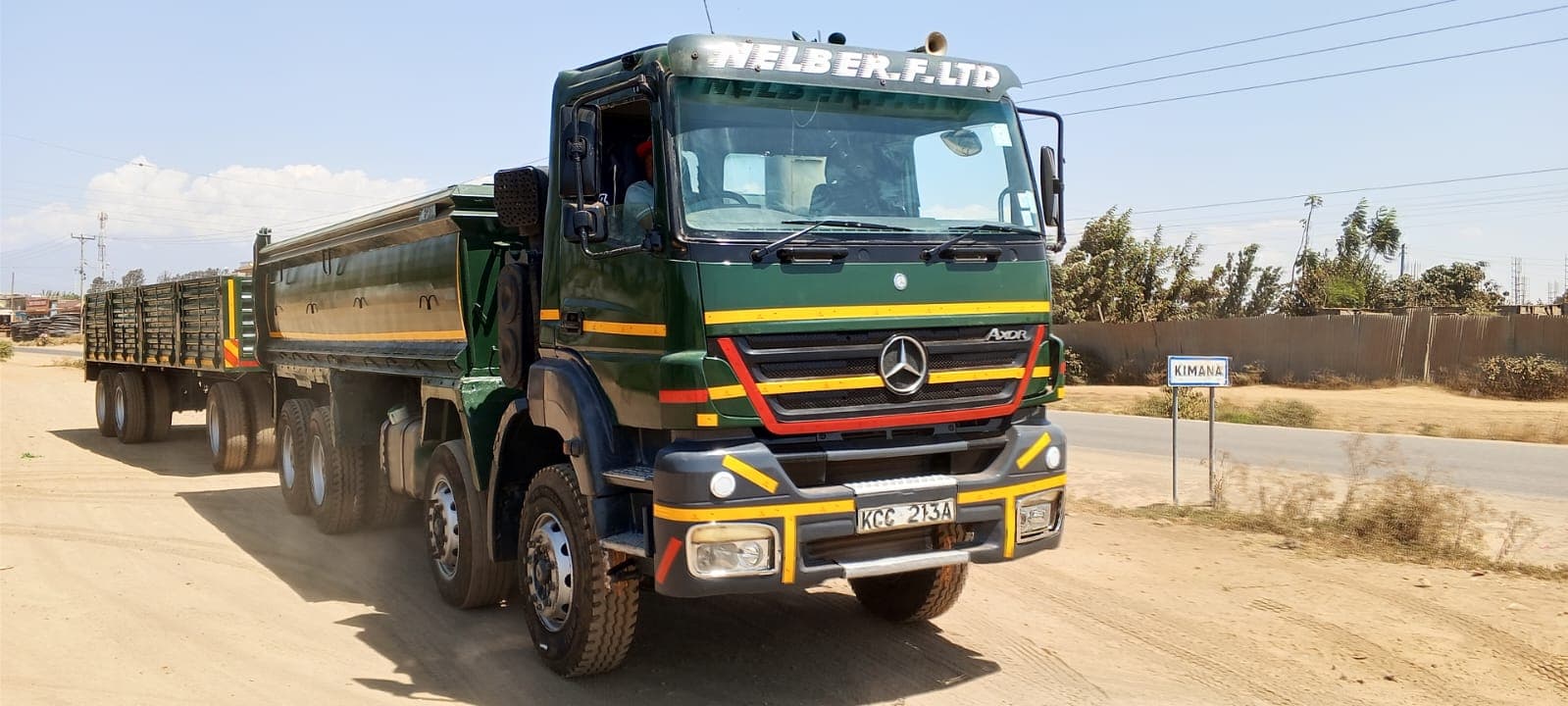 Nelber Mercedes-Benz Axor tipper and trailer passing through Kimana